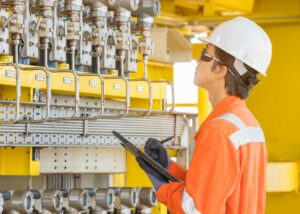 technician-inspecting-equipment-work-order-management-software